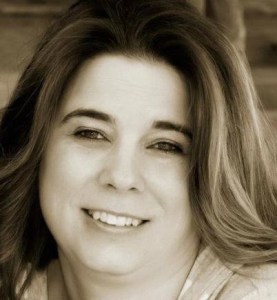 A woman with long hair smiling for the camera.