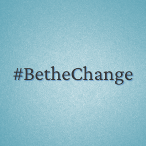 A blue background with the word " bethechange ".