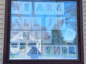 A window with the words we are all in this together written on it.