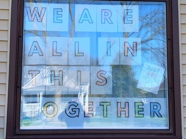 A window with the words we are all in this together written on it.