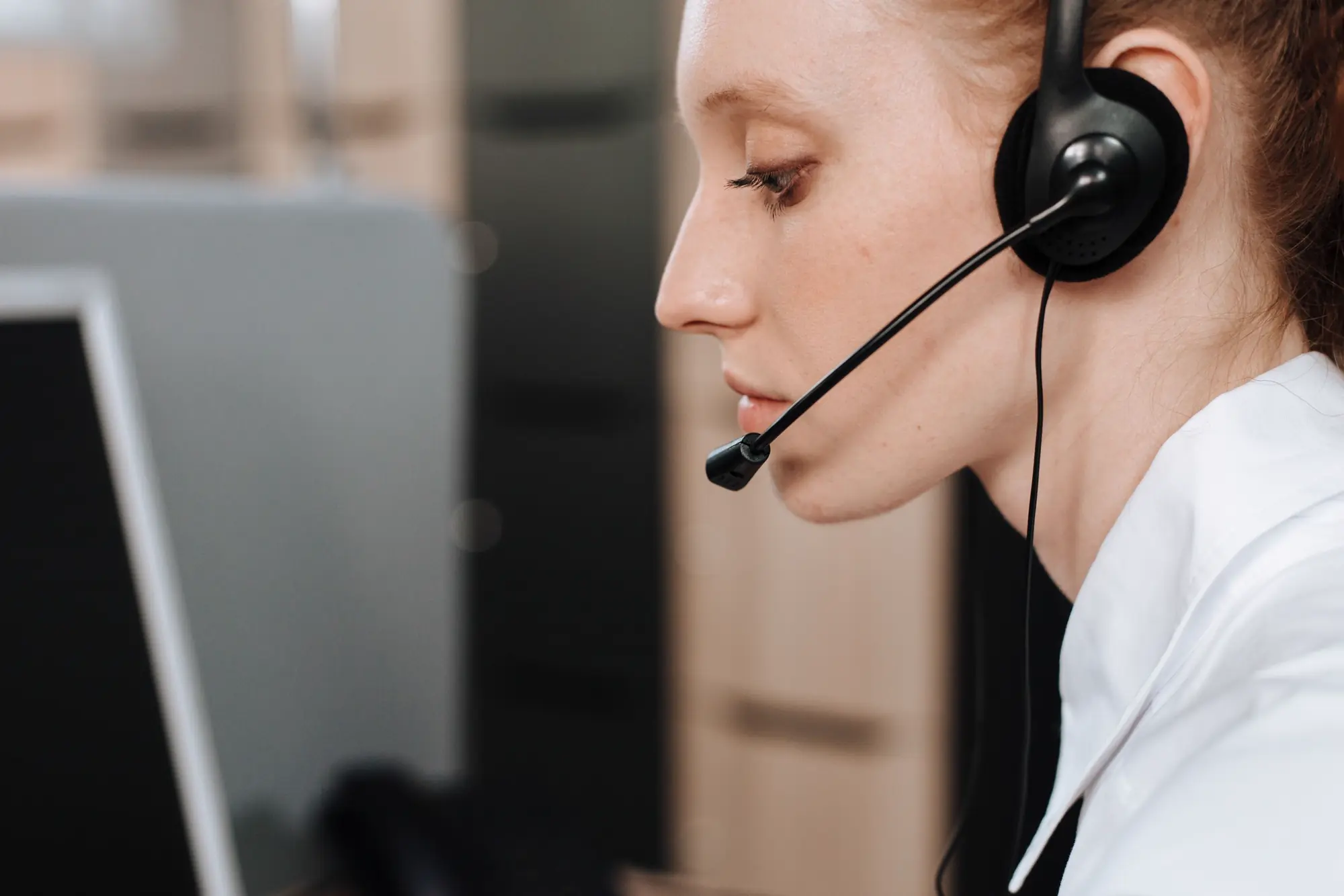 Emergency communications professional wearing a headset at a console