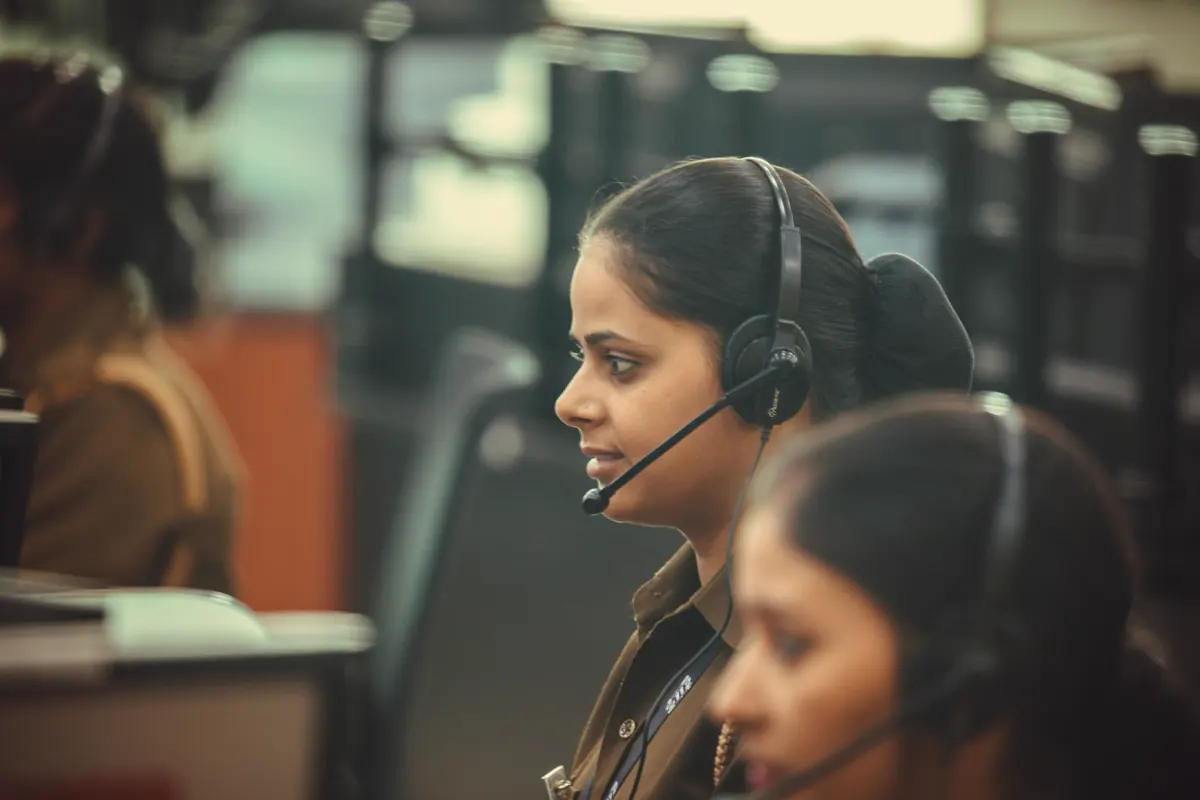 Dispatcher wearing a headset at a computer console