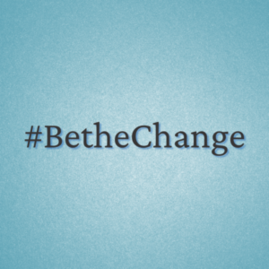 A blue background with the word " bethechange ".